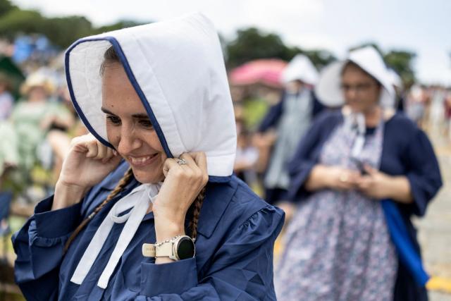 A woman dressed in traditional Voortrekker attire reacts as Afrikaners gather to celebrate the Day of the Vow (Geloftedag) at the Voortrekker Monument in Pretoria on December 16, 2025. The Day of the Vow (Geloftedag), which has since been renamed Reconciliation Day, is celebrated by traditional Afrikaners as the day they defeated the Zulu's at the Battle of Blood River, in KwaZulu Natal, on December 16, 1838. (Photo by Wikus de Wet / AFP)
