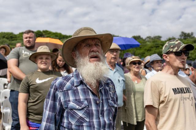 An attendee sings "Die Stem" (the national anthem of South Africa during the apartheid era) at the end of a church service as Afrikaners gather to celebrate the Day of the Vow (Geloftedag) at the Voortrekker Monument in Pretoria on December 16, 2025. The Day of the Vow (Geloftedag), which has since been renamed Reconciliation Day, is celebrated by traditional Afrikaners as the day they defeated the Zulu's at the Battle of Blood River, in KwaZulu Natal, on December 16, 1838. (Photo by Wikus de Wet / AFP)