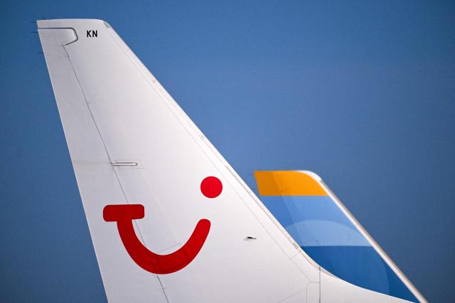The logo of German travel group TUI is pictured on the vertical stabiliser of an airplane outside the new Terminal 3 of Frankfurt Airport (FRA) in Frankfurt am Main, western Germany on December 16, 2025, as part of the chancellor's inaugural visit to the German state of Hesse. Fraport will open the new Terminal 3 on April 22, 2026. (Photo by Kirill KUDRYAVTSEV / AFP)