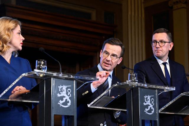 Latvian Prime Minister Evika Silina (L) and Estonian Prime Minister Kristen Michal (R) listen as Swedish Prime Minister Ulf Kristersson addresses a press conference following the EU Eastern Flank Summit in Helsinki, Finland, on December 16, 2025. Defending Europe's eastern flank is an "immediate" priority for the European Union in the face of the threat posed by Russia, eight EU leaders meeting in Helsinki said on December 16. (Photo by Heikki Saukkomaa / Lehtikuva / AFP) / Finland OUT