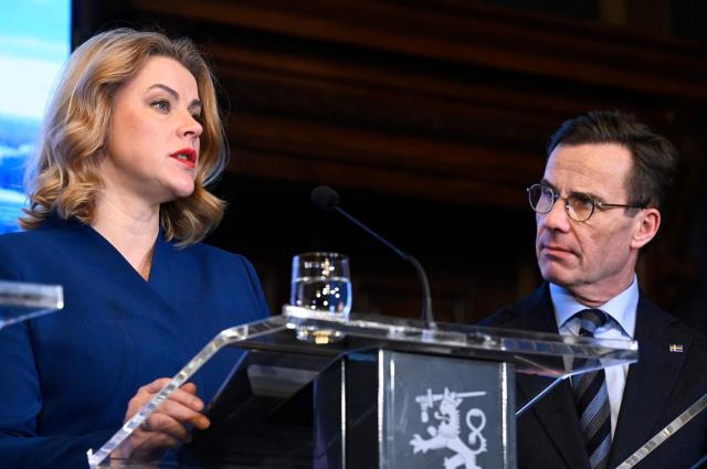 Swedish Prime Minister Ulf Kristersson listens as Latvian Prime Minister Evika Silina (L) addresses a press conference following the EU Eastern Flank Summit in Helsinki, Finland, on December 16, 2025. Defending Europe's eastern flank is an "immediate" priority for the European Union in the face of the threat posed by Russia, eight EU leaders meeting in Helsinki said on December 16. (Photo by Heikki Saukkomaa / Lehtikuva / AFP) / Finland OUT