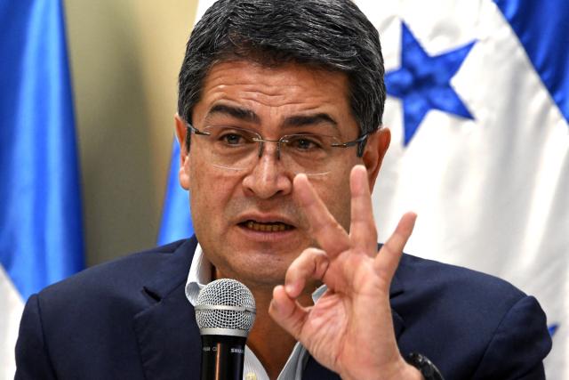(FILES) Honduran reelected President Juan Orlando Hernandez gestures in a press conference in Tegucigalpa, on January 22, 2018. Former Honduran President Juan Orlando Hernandez, pardoned by Donald Trump while serving a sentence for drug trafficking in the United States, denied on December 16, 2025 that he would return to his country. (Photo by Orlando SIERRA / AFP)
