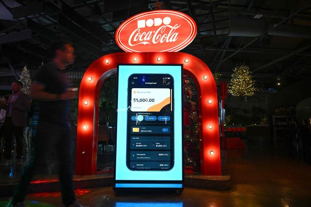 A screen displays the “Kontigo” cryptocurrency app during an event to launch it, in Caracas on December 15, 2025. (Photo by Federico PARRA / AFP)