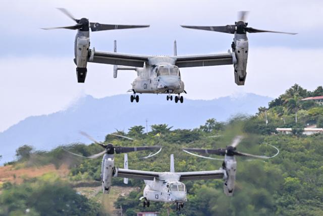 Two US Marine Corps MV-22 Ospreys depart at Mercedita International Airport on December 16, 2025 in Ponce, Puerto Rico. Aircraft movements and coordinated exercises were observed throughout the day as part of heightened regional military readiness linked to ongoing operations at US military bases and maritime security efforts in the Caribbean. President Donald Trump administration is conducting a military campaign in the Caribbean and eastern Pacific, deploying naval and air forces for what it calls an anti-drugs offensive. (Photo by Miguel J. Rodriguez Carrillo / AFP)