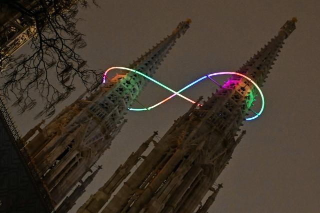 The new light installation "Infinity of Light" by Austrian artist Billi Thanner illuminiates around the steeples of the Votive church in Vienna on December 16, 2026 (Photo by Joe Klamar / AFP) / ALTERNATIVE CROP