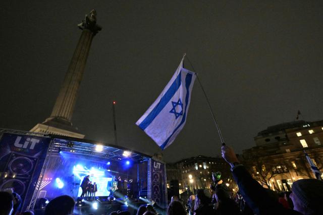 Revellers gather for a "Chanukah LIVE" event for the Jewish festival of Hanukkah at Trafalgar Square in central London on December 16, 2025. The event was held just days after a father and son in Sydney opened fire on crowds gathered for a Jewish festival at Bondi Beach that killed 15 people and wounded dozens. (Photo by Richard A. Brooks / AFP)