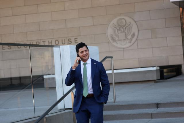 Bill Essayli, First Assistant United States Attorney for the Central District of California, speaks on the phone outside the United States District Court ahead of the sentencing hearing of former medical doctor Mark Chavez on charges of conspiracy to distribute ketamine connected to the overdose death of actor Matthew Perry in Los Angeles, California, on December 16, 2025. (Photo by Patrick T. Fallon / AFP)