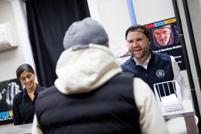 Vice President JD Vance and Second Lady Usha Vance serve food to attendees at the Allentown Rescue Mission in Allentown, Pennsylvania on December 16, 2025. (Photo by Tom BRENNER / POOL / AFP)