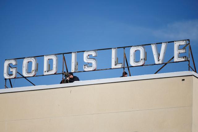 US Secret Service Scout Snipers monitor a rooftop at the Allentown Rescue Mission in Allentown, Pennsylvania on December 16, 2025. (Photo by Tom BRENNER / POOL / AFP)