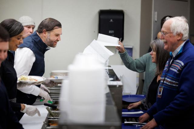 Vice President JD Vance and Second Lady Usha Vance serve food to attendees at the Allentown Rescue Mission in Allentown, Pennsylvania on December 16, 2025. (Photo by Tom BRENNER / POOL / AFP)