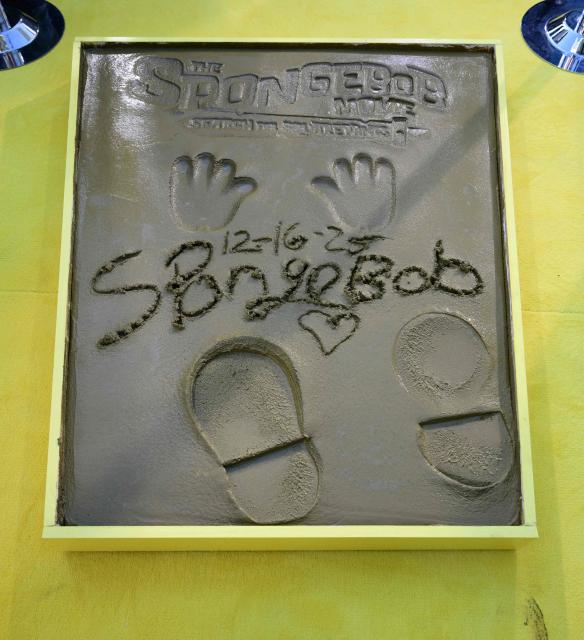 The Hand and Footprints of SpongeBob are seen in the block of cement at a ceremony for SpongeBob on December 16, 2025 at the TCL Chinese Theater in Hollywood, California. (Photo by Frederic J. BROWN / AFP)