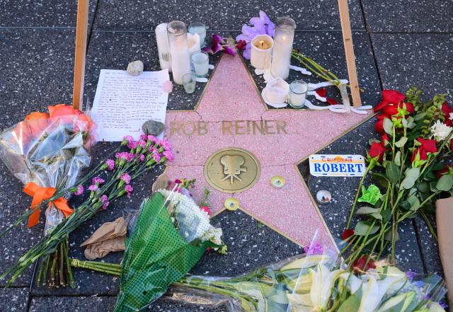 A growing makeshift memorial with flowers, candles and a letter are seen on the Hollywood Walk of Fames Star of the late US actor and director Rob Reiner on December 16, 2025, two days after he and his wife were found dead in the home in Brentwood, California. The son of famed Hollywood director Rob Reiner was not medically cleared for court on Tuesday, his lawyer said, as he awaits formal charging over the double murder of his parents. (Photo by Frederic J. BROWN / AFP)