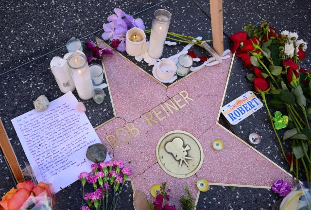A growing makeshift memorial with flowers, candles and a letter are seen on the Hollywood Walk of Fames Star of the late US actor and director Rob Reiner on December 16, 2025, two days after he and his wife were found dead in the home in Brentwood, California. The son of famed Hollywood director Rob Reiner was not medically cleared for court on Tuesday, his lawyer said, as he awaits formal charging over the double murder of his parents. (Photo by Frederic J. BROWN / AFP)