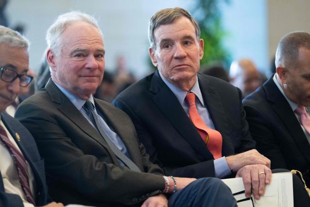US Senator Tim Kaine, Democrat of Virginia, and US Senator Mark Warner (R), Democrat of Virginia, attend a dedication and unveiling of a statue of civil rights activist Barbara Rose Johns of Virginia, in Emancipation Hall on Capitol Hill in Washington, DC, December 16, 2025. In 1951, a 16-year-old Johns, led a walkout at her segregated high school, and now her statue replaces one of confederal General Robert E. Lee, which was removed from the Capitol in 2020. (Photo by SAUL LOEB / AFP)