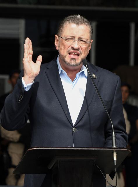 (FILES) Costa Rica's President Rodrigo Chaves delivers a speech after inspecting seized cocaine packs in Alajuela, Costa Rica on November 28, 2025. Rodrigo Chaves faces Congress on December 16, 2025, over the possibility of losing his immunity, a step toward possible removal for allegedly influencing the 2026 election campaign. (Photo by EZEQUIEL BECERRA / AFP)