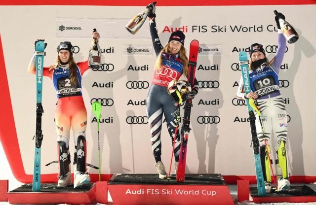 (from L) Second placed Switzerland's Camille Rast, winner US' Mikaela Shiffrin and third placed Germany's Emma Aicher celebrate on the podium after the FIS Alpine Skiing women's World Cup 2025-2026 slalom in Courchevel, French Alps, on December 16, 2025. (Photo by Jeff PACHOUD / AFP)