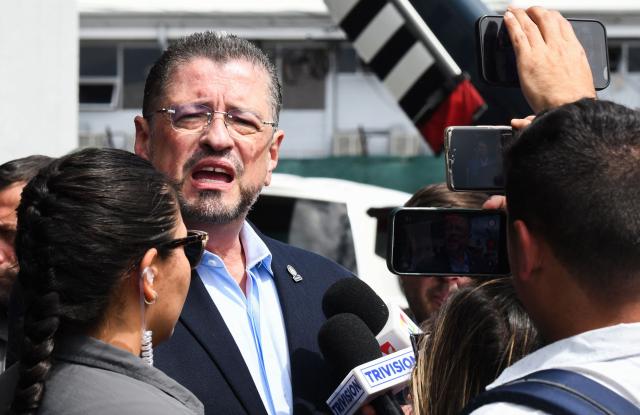 (FILES) Costa Rica's President Rodrigo Chaves speaks to members of the media after inspecting seized cocaine packs in Alajuela, Costa Rica on November 28, 2025. Rodrigo Chaves faces Congress on December 16, 2025, over the possibility of losing his immunity, a step toward possible removal for allegedly influencing the 2026 election campaign. (Photo by EZEQUIEL BECERRA / AFP)