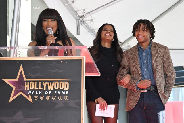 Bronwyn Vance (C) and Slater Vance (R) listen to their mother US actress Angela Bassett speak at the Hollywood Walk of Fame star unveiling ceremony for her husband actor Courtney B. Vance in Hollywood, California, on December 16, 2025. (Photo by Robyn Beck / AFP)