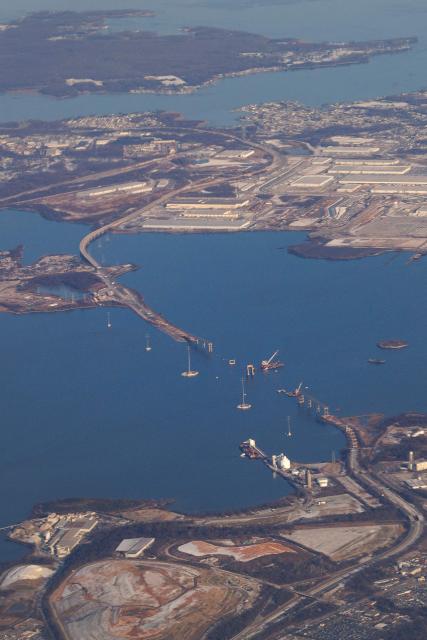 Boats pass along the Patapsco River near the site of the fallen Francis Scott Key Bridge, on December 16, 2025. On March 26, 2024, the Dali, a 984-foot Singapore-flagged container ship, suffered a series of electrical problems and crashed into the Francis Scott Key Bridge over the Patapsco River in Maryland, which collapsed like a house of cards. (Photo by Tom BRENNER / POOL / AFP)