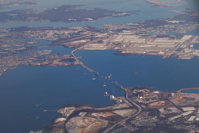 Boats pass along the Patapsco River near the site of the fallen Francis Scott Key Bridge, on December 16, 2025. On March 26, 2024, the Dali, a 984-foot Singapore-flagged container ship, suffered a series of electrical problems and crashed into the Francis Scott Key Bridge over the Patapsco River in Maryland, which collapsed like a house of cards. (Photo by Tom BRENNER / POOL / AFP)