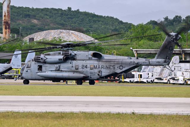 A US Marine CH-53 Sea Stallion taxis at Mercedita International Airport on December 16, 2025 in Ponce, Puerto Rico. Aircraft movements and coordinated exercises were observed throughout the day as part of heightened regional military readiness linked to ongoing operations at US military bases and maritime security efforts in the Caribbean. President Donald Trump administration is conducting a military campaign in the Caribbean and eastern Pacific, deploying naval and air forces for what it calls an anti-drugs offensive. (Photo by Miguel J. Rodriguez Carrillo / AFP)
