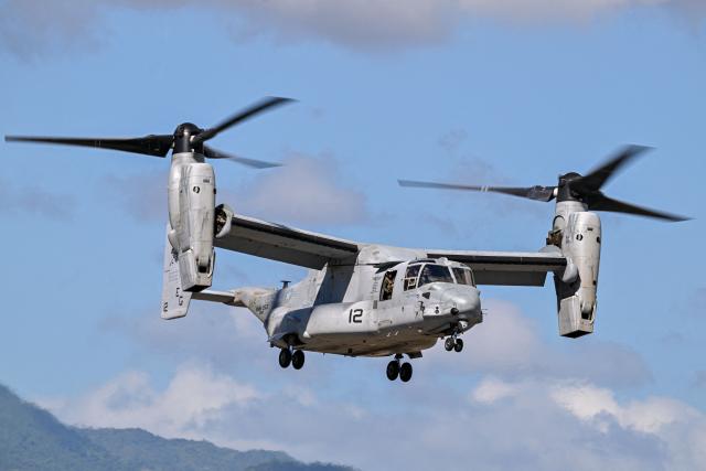 A US Marine Corps MV-22 Osprey departs from Mercedita International Airport on December 16, 2025 in Ponce, Puerto Rico. Aircraft movements and coordinated exercises were observed throughout the day as part of heightened regional military readiness linked to ongoing operations at US military bases and maritime security efforts in the Caribbean. President Donald Trump administration is conducting a military campaign in the Caribbean and eastern Pacific, deploying naval and air forces for what it calls an anti-drugs offensive. (Photo by Miguel J. Rodriguez Carrillo / AFP)