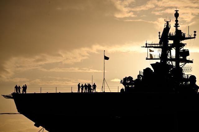 The Wasp-class amphibious assault ship USS Iwo Jima (LHD7) is docked at Rafael Cordero Santiago Port of the America on December 16, 2025 in Ponce, Puerto Rico. President Donald Trump administration is conducting a military campaign in the Caribbean and eastern Pacific, deploying naval and air forces for what it calls an anti-drugs offensive. (Photo by Miguel J. Rodriguez Carrillo / AFP)