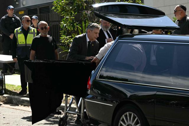 The coffin of rabbi Eli Schlanger, who was killed in the December 14 Bondi beach attack, is seen at his funeral at the Chabad of Bondi in Sydney on December 17, 2025. (Photo by Saeed KHAN / AFP)