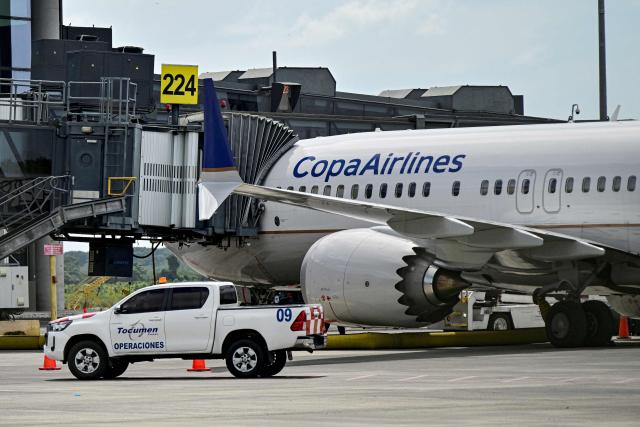 (FILES) A Copa Airlines aircraft sits on the tarmac at Tocumen International Airport in Panama City, on December 4, 2025. Panamanian airline Copa extended the suspension of its flights to and from Caracas until January 15, 2026, just as the United States renewed its warning against flying over Venezuelan airspace due to risks posed by military activity in the region. (Photo by Martin BERNETTI / AFP)