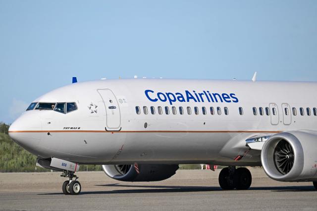 (FILES) A Copa Airlines plane is pictured at Simon Bolivar International Airport in Maiquetia, Venezuela, on December 3, 2025. Panamanian airline Copa extended the suspension of its flights to and from Caracas until January 15, 2026, just as the United States renewed its warning against flying over Venezuelan airspace due to risks posed by military activity in the region. (Photo by Juan BARRETO / AFP)
