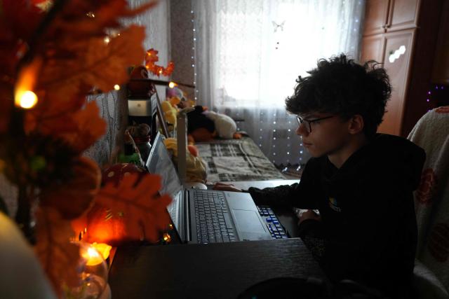 Bohdan Levchykov, a 15-year-old teenager, poses in his own room in Balakliia, on October 13, 2025. With his bumfluff moustache and baseball cap, Bohdan Levchykov would be your typical teenager anywhere if he didn't embody what has happened to a generation of young Ukrainians after nearly four years of war. Researchers for the WHO who questioned 24,000 young Ukrainians from 11 to 17 at the end of 2023 found a "deterioration in the psychological wellbeing" and "significant" decrease in the happiness they felt. (Photo by OLEKSII FILIPPOV / AFP)