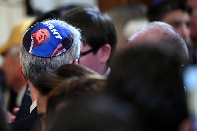 Guests attend a Hanukkah reception hosted by US President Donald Trump in the East Room of the White House in Washington, DC on December 16, 2025. (Photo by ANDREW CABALLERO-REYNOLDS / AFP)