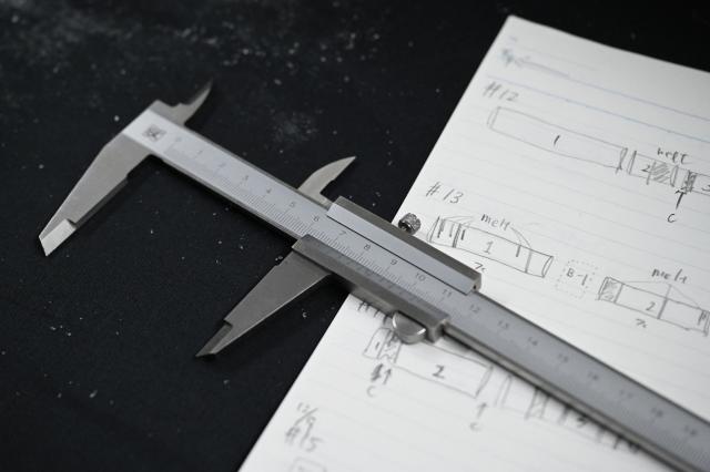 Sketches and descriptions of an ice core sample taken from a glacier in the Pamir mountain range in Tajikistan, are seen on a sheet at the Hokkaido University Institute of Low Temperature Science, in Sapporo, in northern Japans Hokkaido prefecture on December 9, 2025. Dressed in an orange puffer jacket, Japanese glacier scientist Yoshinori Iizuka stepped into a storage freezer chilled to minus 50 Celcius to retrieve an ice core. (Photo by GREG BAKER / AFP) / TO GO WITH: Japan-Tajikistan-climate-science-environment-research, FOCUS by Hiroshi HIYAMA