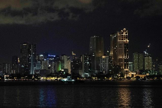 This photo shows a general view of the skyline as seen from Manila Bay in Manila on December 16, 2025. (Photo by Ted ALJIBE / AFP)