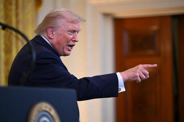 US President Donald Trump points to attendees during a Hanukkah reception in the East Room of the White House in Washington, DC on December 16, 2025. (Photo by ANDREW CABALLERO-REYNOLDS / AFP)