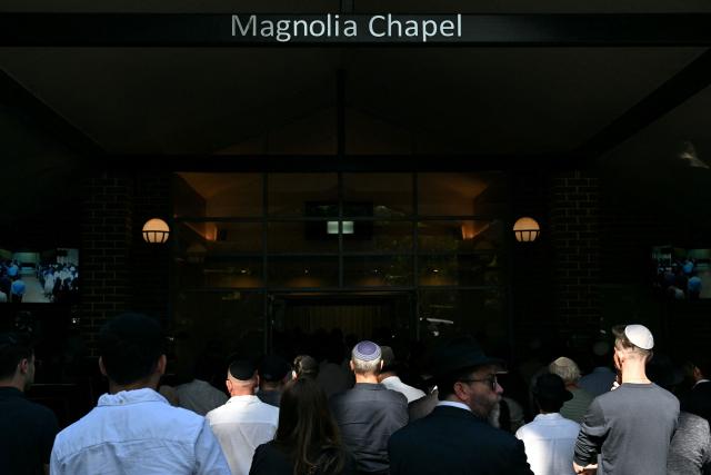 Mourners attend the funeral of Yaakov Levitan Halevi, a victim of Sunday’s Bondi Beach attack, at the Magnolia Chapel at Macquarie Park Cemetery in Sydney on December 17, 2025. Police charged alleged Bondi killer Naveed Akram with terrorism, 15 counts of murder and a litany of other crimes after Australia's worst mass shooting in decades. (Photo by Saeed KHAN / AFP)