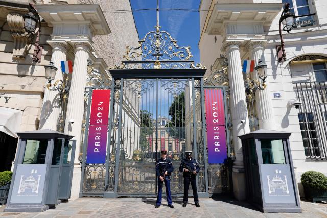 (FILES) Police officers stand guard outside the French interior ministry, place Beauvau, adorned with Paris 2024 Olympics banners during a ceremony marking the arrival of the Paris 2024 Olympics and Paralympics flags at the Interior ministry in Paris, on April 23, 2024. France's Interior Minister Laurent Nunez announced on December 18, 2025 that "A few tens" of confidential files have been "extracted" in a hacking attack on France's Interior Ministry IT infrastructure. (Photo by Ludovic MARIN / AFP)