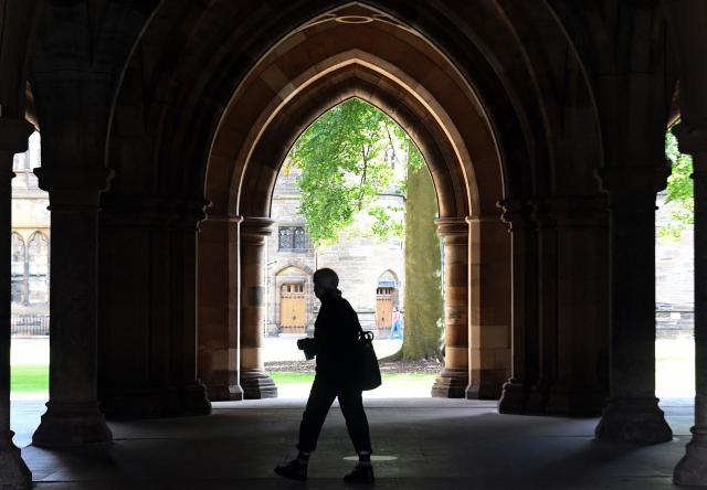 (FILES) A student walks in the campus of Glasgow University complex in Glasgow, Scotland on September 24, 2020. Britain is to rejoin the European Union's Erasmus student exchange programme, which it left almost five years ago following Brexit, a joint UK-EU statement said on December 17, 2025. (Photo by Andy Buchanan / AFP)