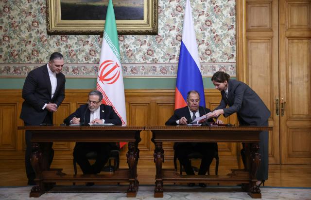 Russian Foreign Minister Sergei Lavrov and his Iranian counterpart Abbas Araghchi attend a signing ceremony following their talks in Moscow on December 17, 2025. (Photo by Ramil Sitdikov / POOL / AFP)
