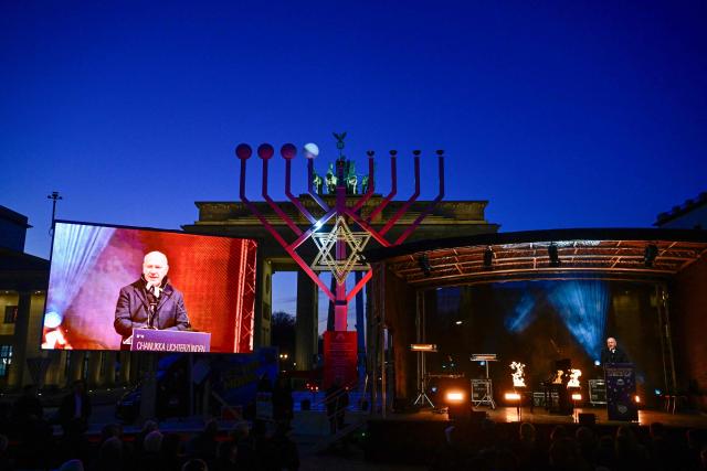 Berlin Mayor Kai Wegner addresses guests during the central Hanukkah candle lighting ceremony at the Brandenburg Gate in Berlin on December 17, 2025. (Photo by John MACDOUGALL / AFP)
