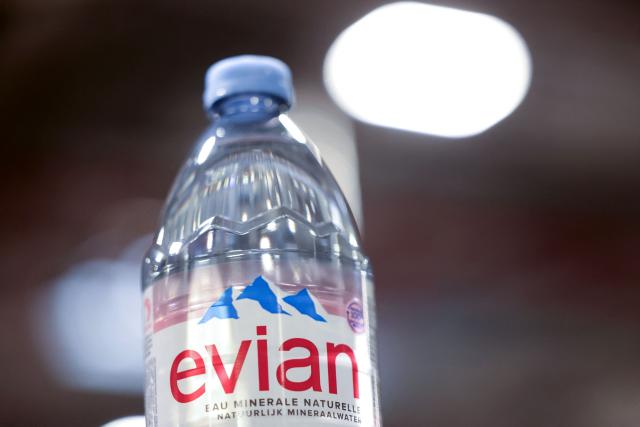 This photograph shows a bottle of Evian on an assembly line at the Evian water bottling plant, in Publier, eastern France on December 16, 2025. (Photo by Alex MARTIN / AFP)