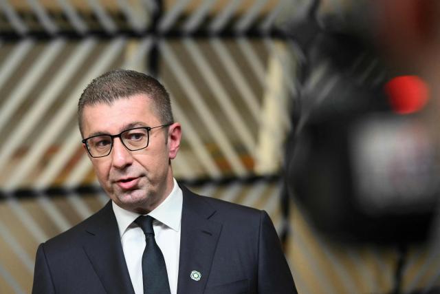North Macedonia's Prime Minister Hristijan Mickoski addresses media as he arrives to attend the EU Western Balkans summit ahead of the European Council in Brussels on December 17, 2025. (Photo by NICOLAS TUCAT / AFP)