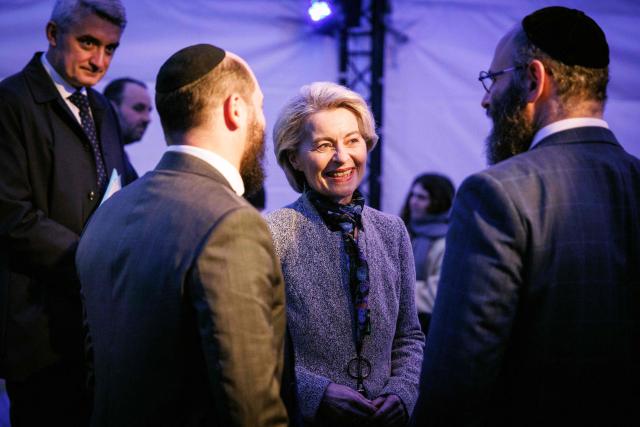 European Commission President Ursula von der Leyen speaks with rabbis as she takes part in the Euro-Chanukah event organized by the European Jewish Community Center (EJCC) together with the European Jewish Association (EJA) outside the European Union buildings in Brussels on December 17, 2025. (Photo by Simon Wohlfahrt / AFP)