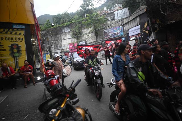 Flamengo supporters react as they watch the final match of 2025 FIFA Intercontinental Cup between Paris Saint-Germain and Flamengo at Rocinha favela in Rio de Janeiro, Brazil on December 17, 2025. (Photo by MAURO PIMENTEL / AFP)