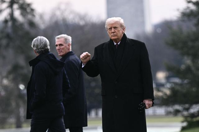 US President Donald Trump raises his fist as he walks to board Marine One as he departs from the South Lawn of the White House in Washington, DC, on December 17, 2025 to attend a ceremony for the return of two US servicemen killed in Syria at Dover Air Force Base in Delaware. (Photo by Brendan SMIALOWSKI / AFP)