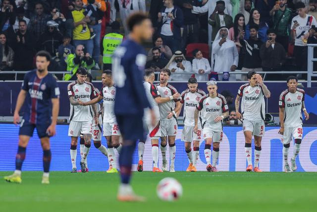 CR Flamengo’s players celebrate after Brazilian midfielder #21 Jorginho scored his team's first goal from the penalty spot during the 2025 FIFA Intercontinental Cup final football match between Paris Saint-Germain (PSG) and CR Flamengo at the Ahmad bin Ali Stadium in Al-Rayyan on the outskirts of Doha on December 17, 2025. (Photo by Karim JAAFAR / AFP)