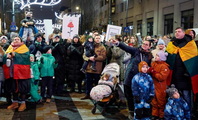 People take part in a protest at Independence Square in Vilnius on December 17, 2025 against proposed changes to the management of the national broadcaster LRT, citing threats to media freedom. Public service media are under political and financial pressures in a number of EU countries from governments attempting to increase control, including by manipulating governance structures and influencing editorial coverage. (Photo by Petras Malukas / AFP)