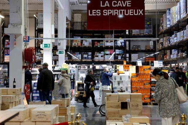 Customers shop during a press visit at the multinational wholesale chain 'Metro' flagship store in Nanterre, western Paris, on December 17, 2025. (Photo by Charlotte SIEMON / AFP)