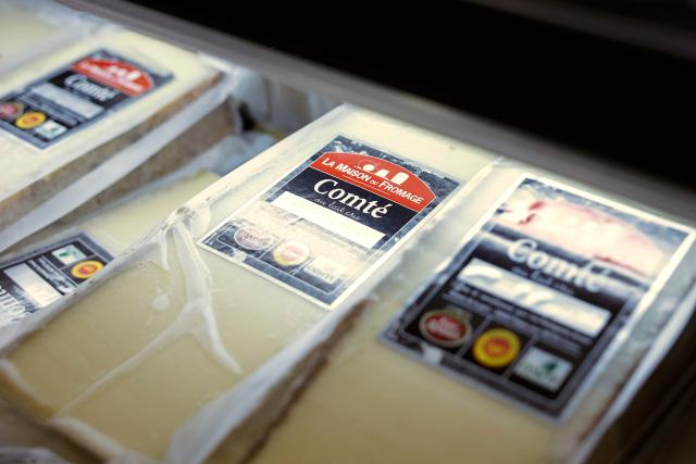 This photograph shows Comte cheese on display at the multinational wholesale chain 'Metro' flagship store in Nanterre during a press visit, in western Paris, on December 17, 2025. (Photo by Charlotte SIEMON / AFP)