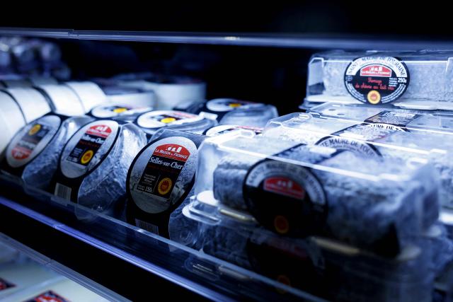 This photograph shows goat cheese on display at the multinational wholesale chain 'Metro' flagship store in Nanterre during a press visit, in western Paris, on December 17, 2025. (Photo by Charlotte SIEMON / AFP)